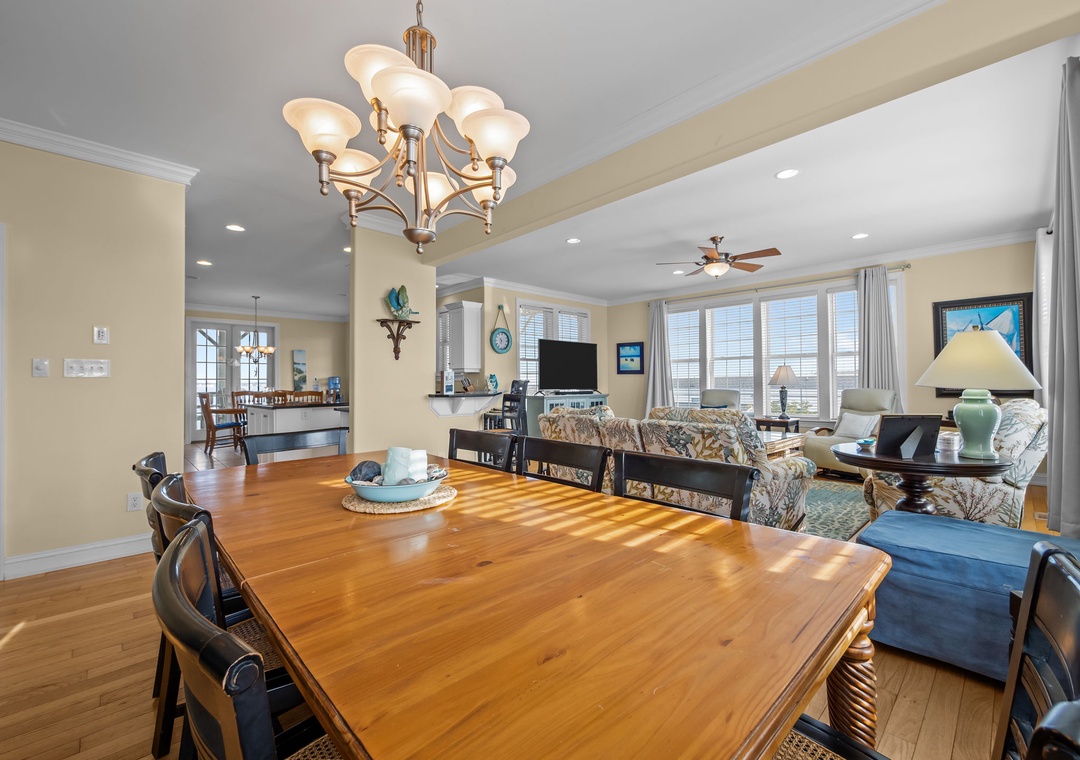 Gather around this beautiful wood table where sunlight streams through creating perfect moments for meals and conversation in your coastal retreat.