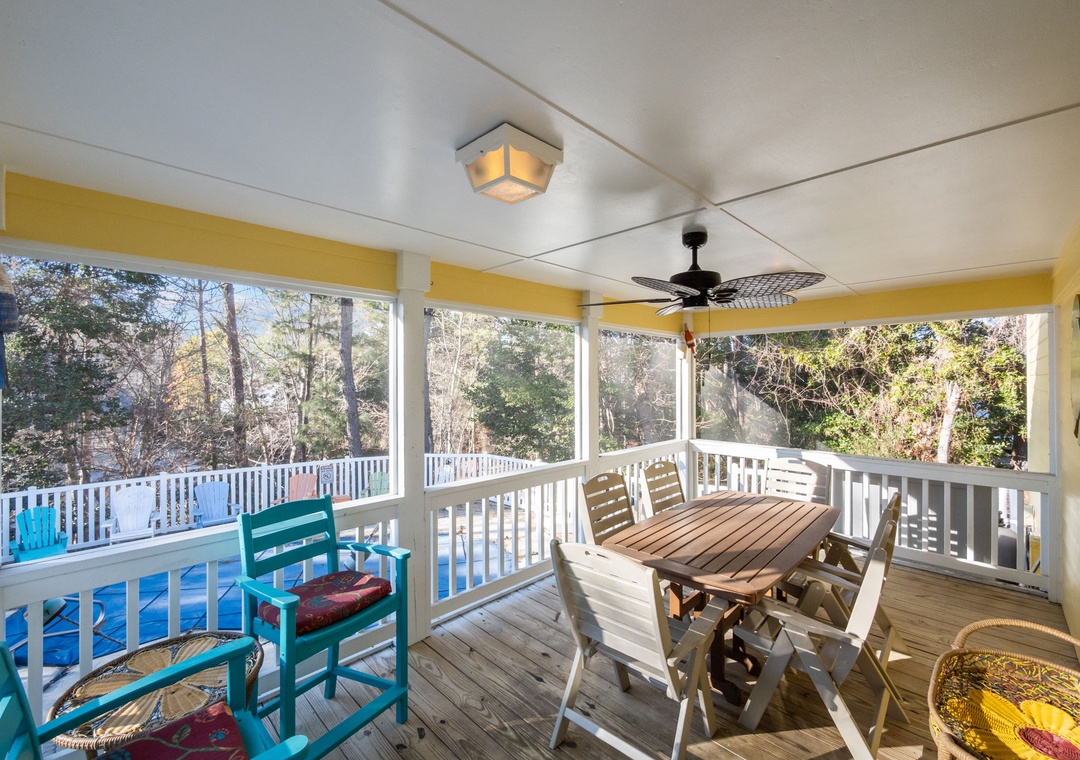 Your screened porch offers peaceful dining with pool views, ceiling fan comfort, and charming outdoor furniture for memorable meals.