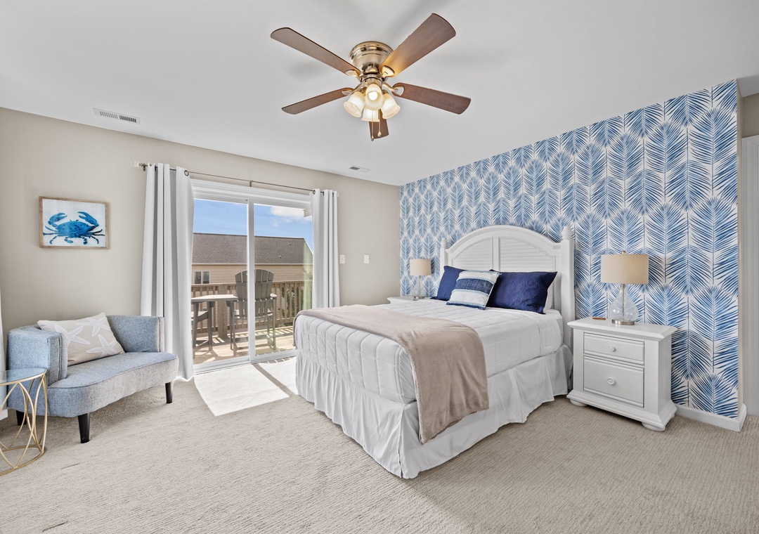 Your coastal bedroom combines comfort and style with a plush bed, cozy seating nook, and bright balcony access for morning coffee.