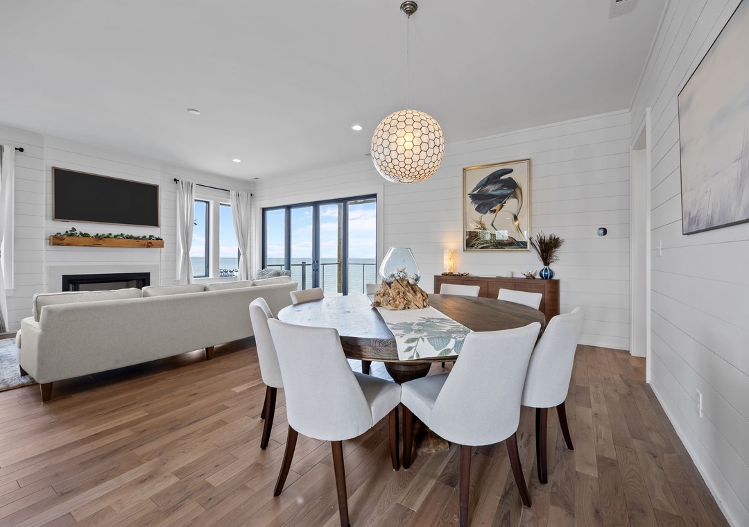 Gather around your elegant dining table for memorable meals, while natural light fills this stylish space with stunning views.