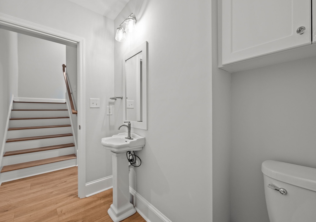 Freshen up in your stylish powder room featuring clean lines, modern fixtures, and bright lighting for your comfort.