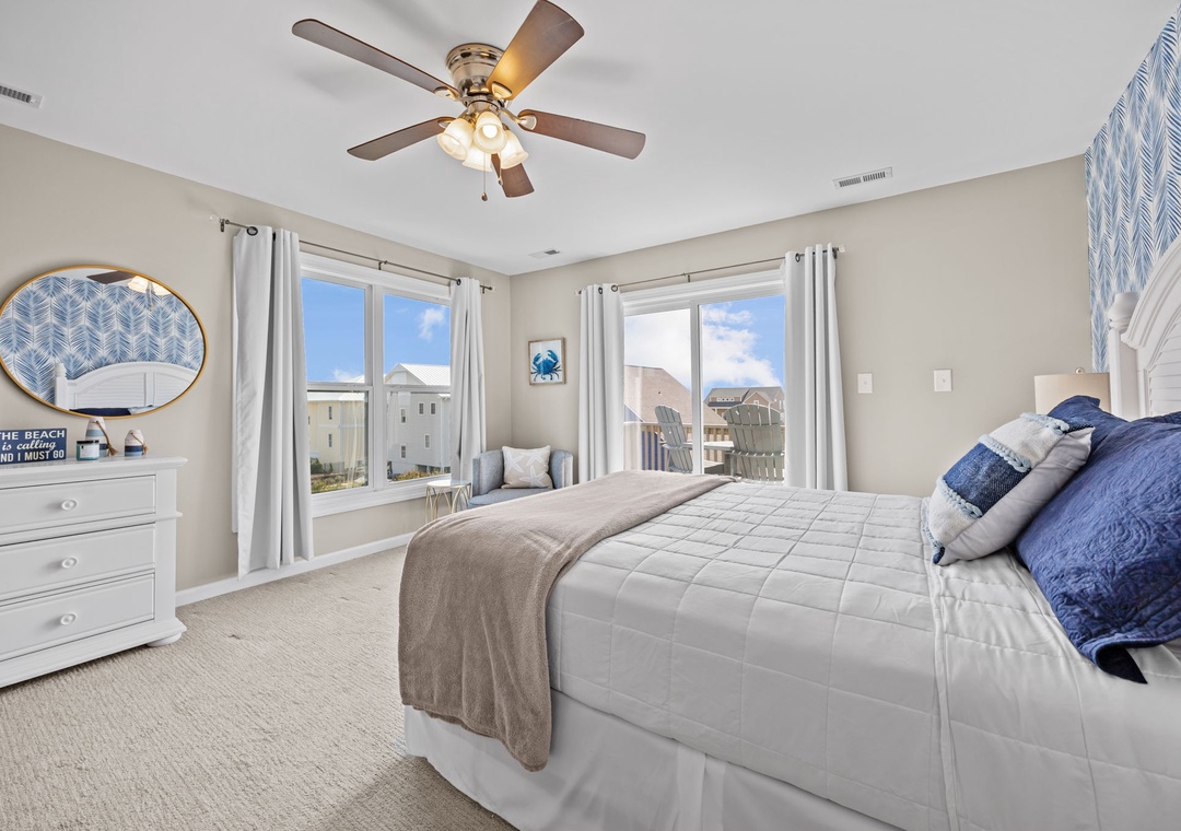Wake up refreshed in your coastal bedroom with soft blue accents and natural light streaming through your windows.