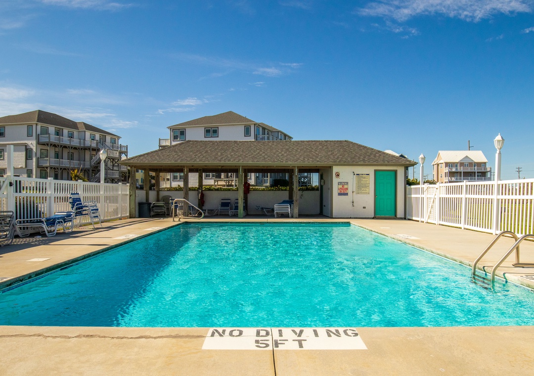 Sparkling pool with covered pavilion creates your perfect retreat for sunny days and poolside relaxation.