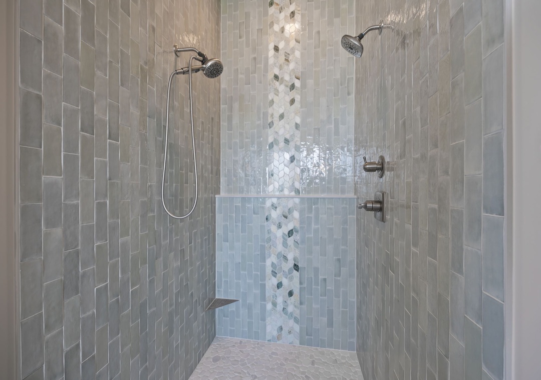 Step into your luxurious dual-head shower with stunning mosaic tilework and rainfall heads for the ultimate spa experience.