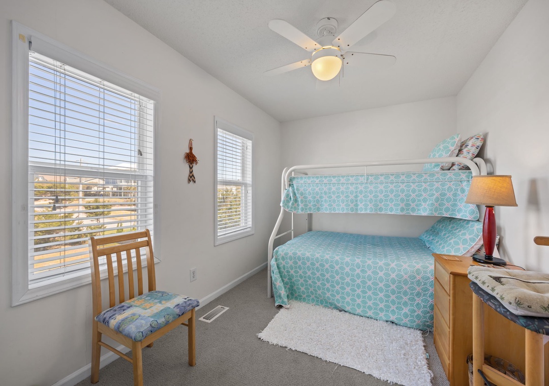 Cozy kids' room with cheerful turquoise bunk beds where your little ones will drift off to sleep after beach adventures.