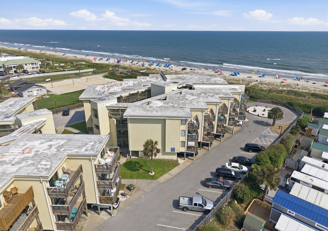 Char’s Cozy Condo | Building and Nearby Beach
