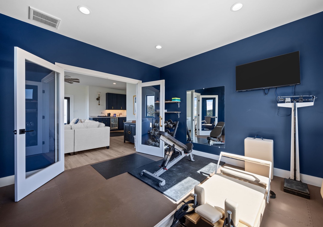 Your private fitness sanctuary awaits with professional equipment and inspiring blue walls to energize your workout routine.