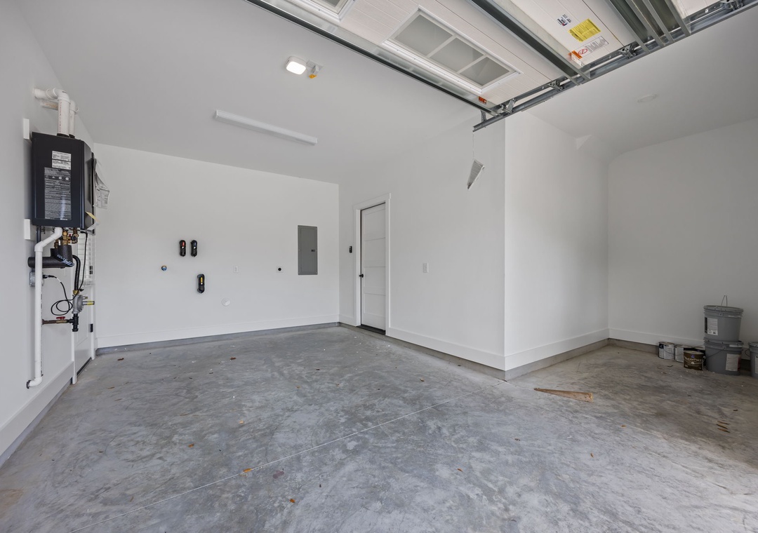 Spacious garage with clean walls and concrete flooring provides convenient parking for your vehicle during your stay.