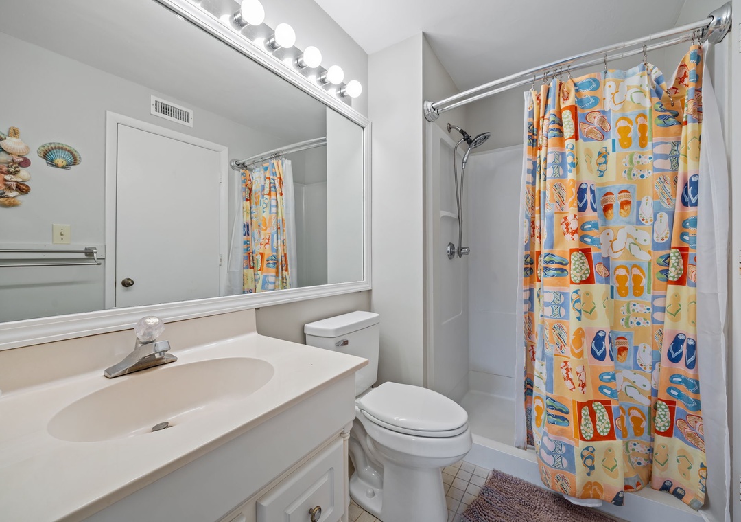 Freshen up in your bright, cheerful bathroom with playful beach-themed touches and all the essentials for a comfortable stay.