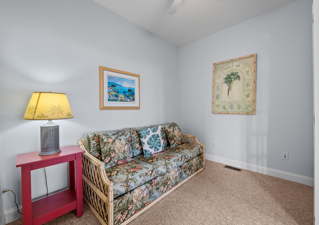 Sink into tropical comfort on your woven sofa, where beach-themed art and soft lighting create your perfect island retreat.
