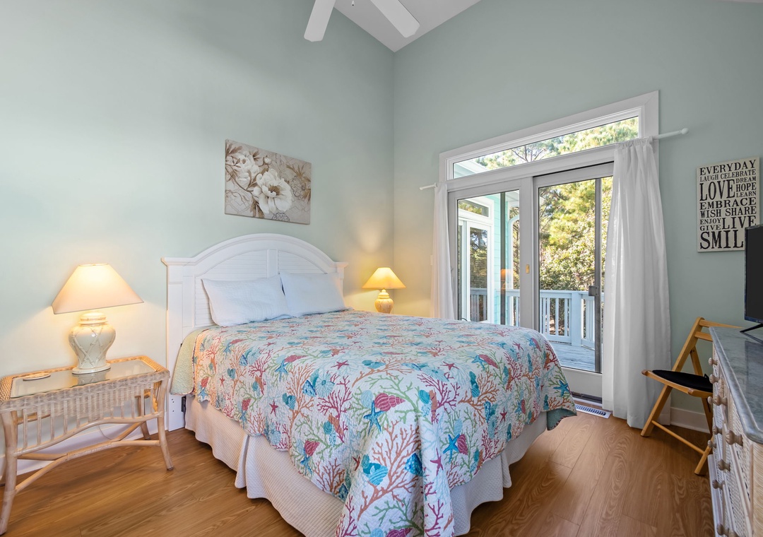 Drift off peacefully in your coastal-themed bedroom featuring coral-patterned bedding, soft lighting, and French doors opening to your private balcony.