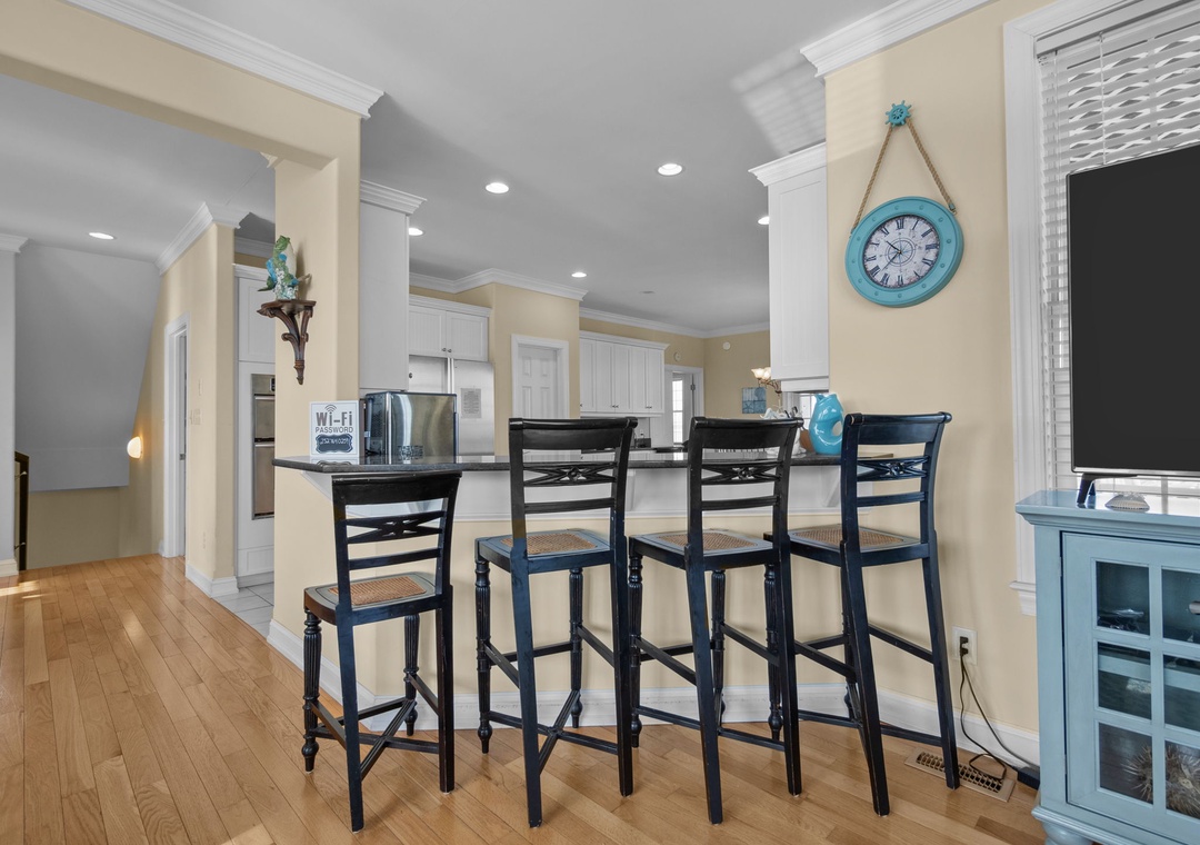 Gather around your beautiful breakfast bar with elegant seating for four, perfect for morning coffee or casual meals in this bright, welcoming space.