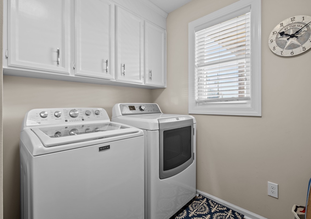 Your dedicated laundry room features full-size washer and dryer with convenient upper cabinets for storage.