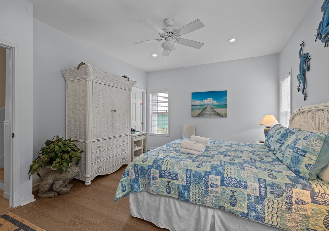 Drift off in this serene coastal bedroom featuring tropical blue linens, warm lighting, and beachy décor that'll make you feel like you're sleeping by the ocean.