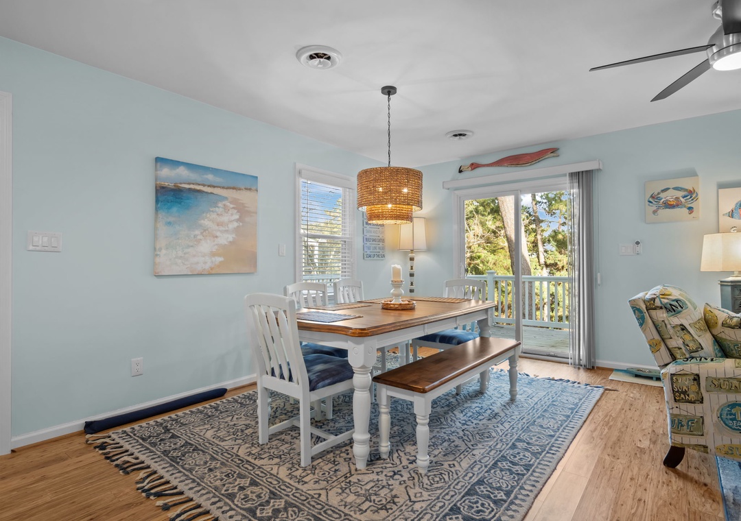 Gather around this inviting dining table where coastal charm meets comfort. Natural light streams through your private balcony doors, perfect for memorable meals together.
