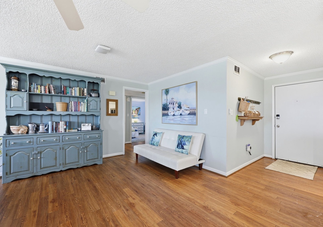 Settle into a cozy living space with coastal charm and a sofa where you can unwind after your adventures, surrounded by thoughtful décor that makes you feel right at home.