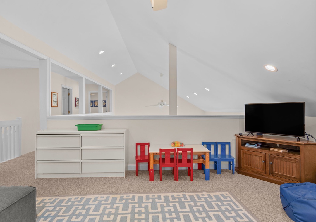 Your kids will love this dedicated play area with colorful furniture, games, and entertainment setup in the bright upstairs loft.