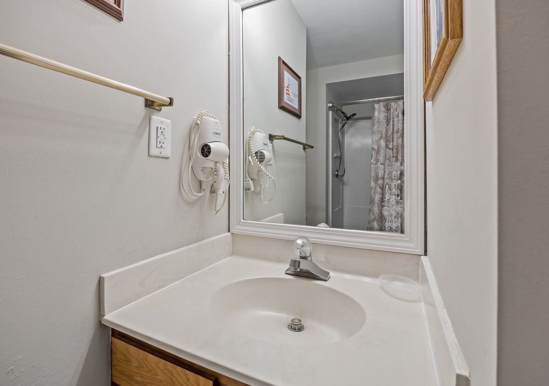 Your private bathroom features a spacious vanity with convenient hair dryer and well-lit mirror for your morning routine.