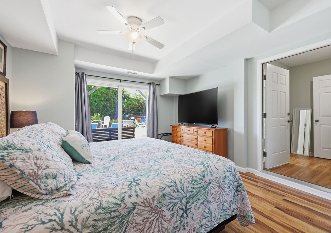 Wake up to bright mornings in your serene bedroom, where coastal-inspired bedding and gleaming hardwood floors create a calming retreat. Step outside to your private patio access for morning coffee.