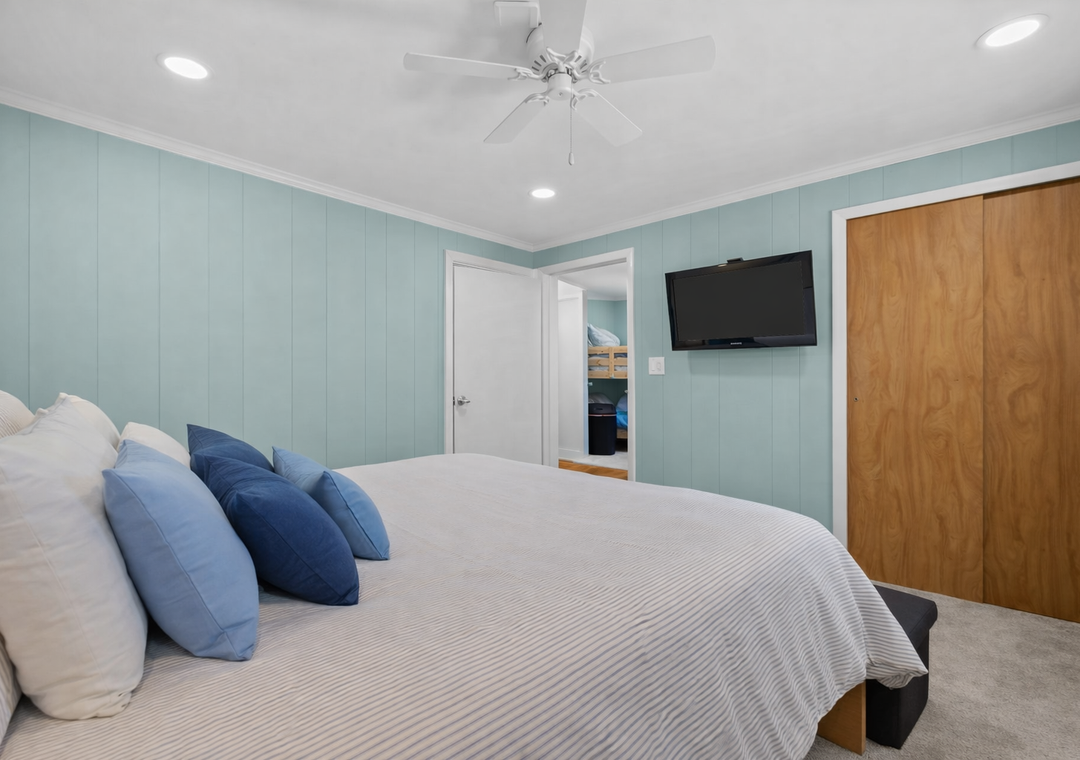 Your coastal retreat features soft blue accents and crisp linens, with gentle ceiling fan breezes keeping you comfortable year-round.