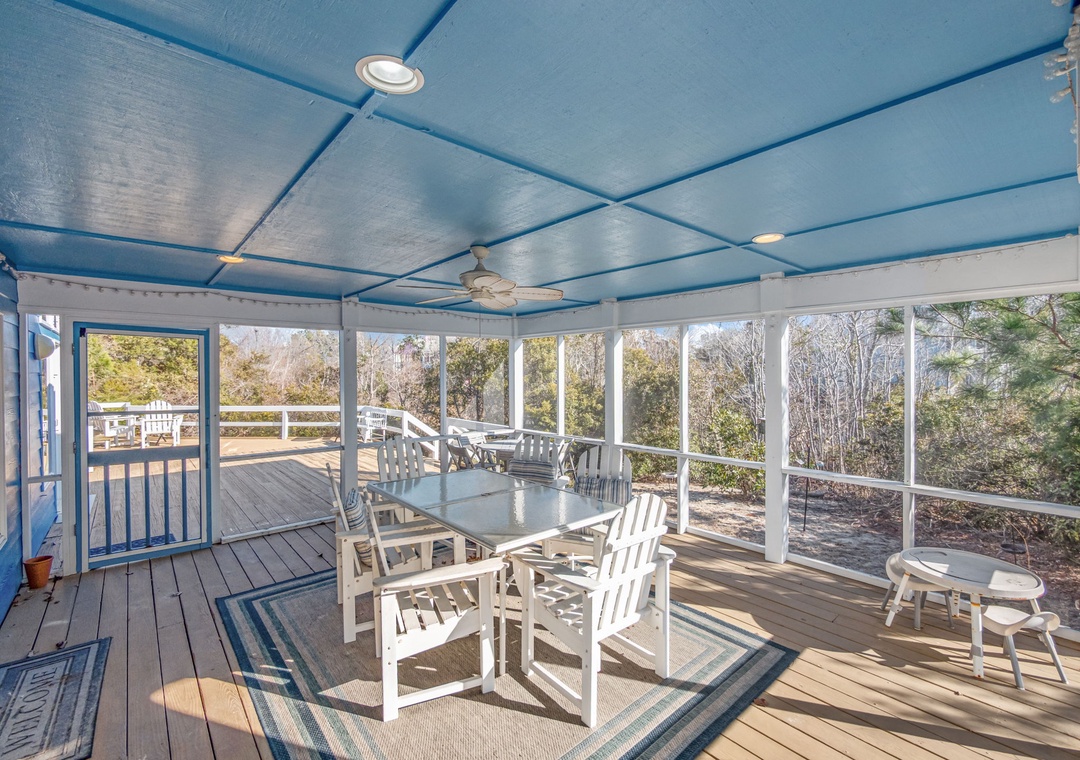 Your screened-in dining area offers perfect protection while you savor meals surrounded by peaceful wooded views.