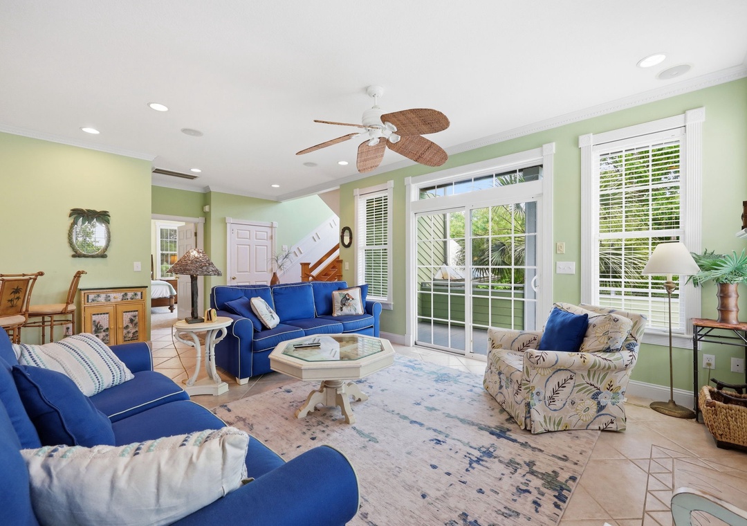 Sink into plush sofas in your bright living space, where tropical breezes drift through glass doors and cheerful colors invite you to truly unwind and feel at home.