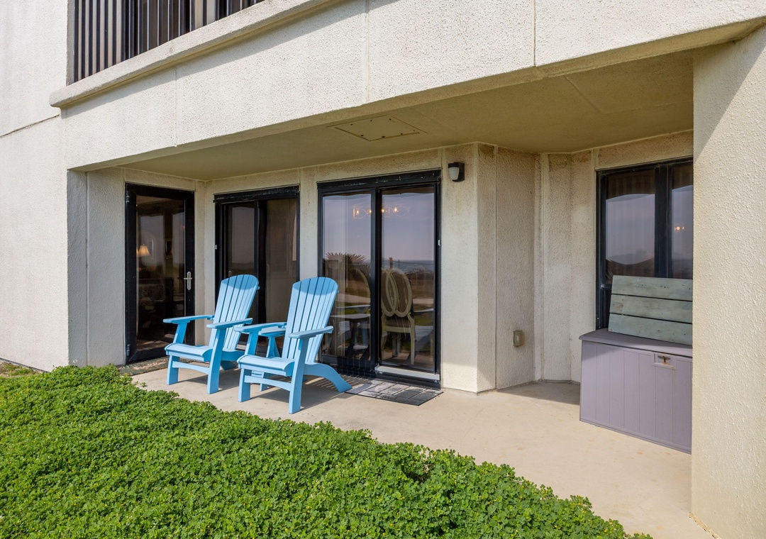 Relax in your bright blue Adirondack chairs on your private patio, where glass doors open to reveal your peaceful coastal retreat.
