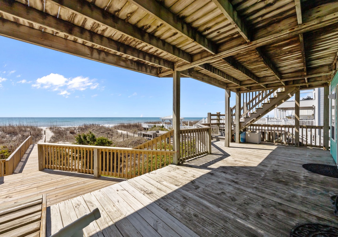 Expansive oceanfront deck with stunning sea views and direct beach access.