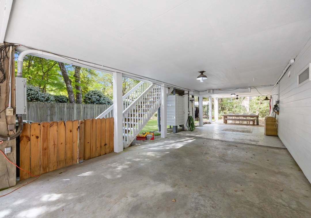 Your covered parking area provides secure vehicle storage with convenient access to your upstairs accommodation and peaceful garden views.