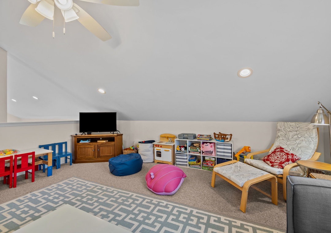 Your family will love this bright playroom with toys, games, and cozy seating for parents to relax while kids play.