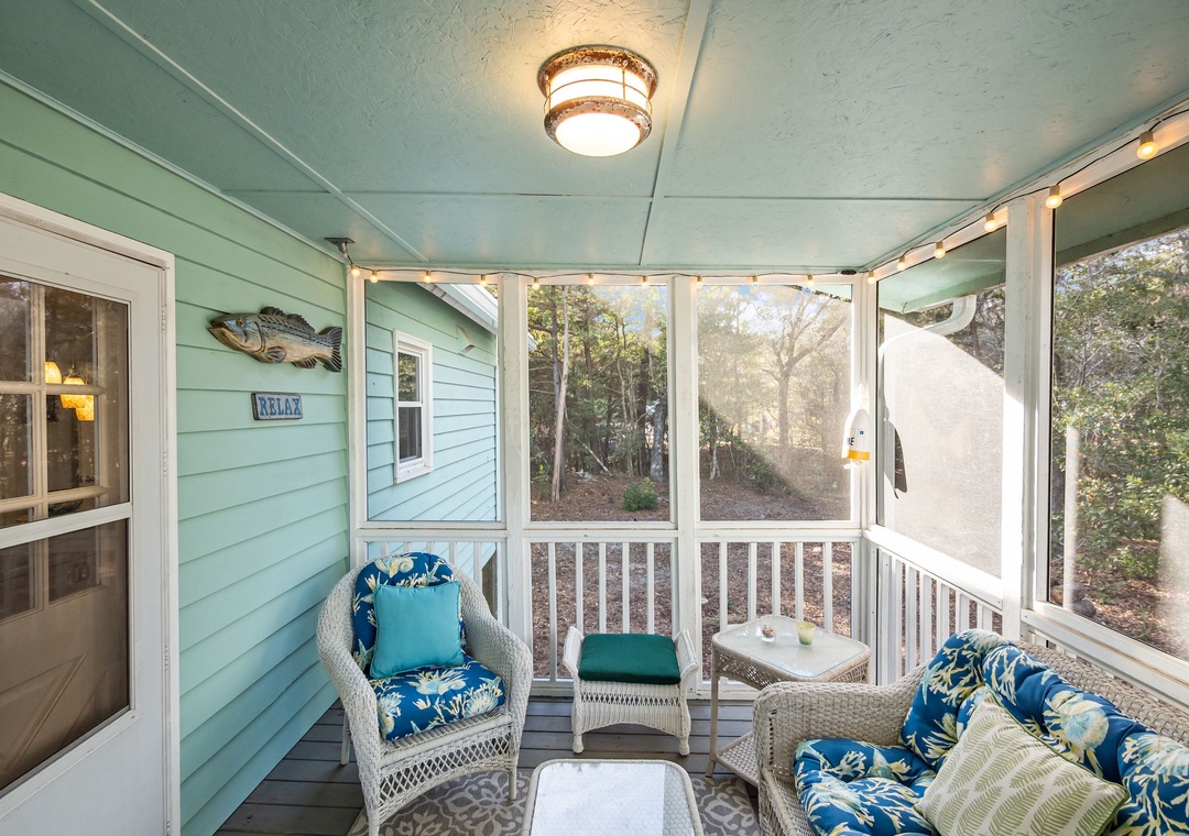 Settle into your screened porch sanctuary with plush wicker seating and tropical cushions, perfect for your morning coffee or evening unwind.
