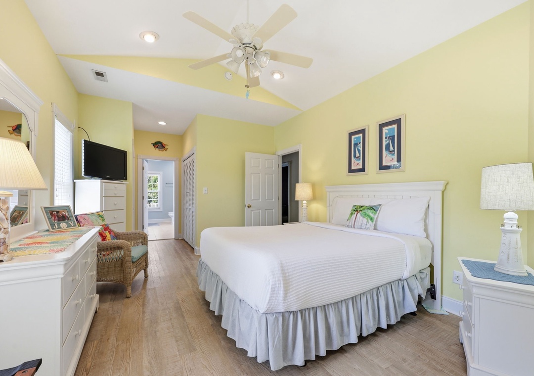 Drift off to sleep in your cheerful, sunlit bedroom with crisp linens, gentle ceiling fan breezes, and coastal décor creating a calming retreat after your day.