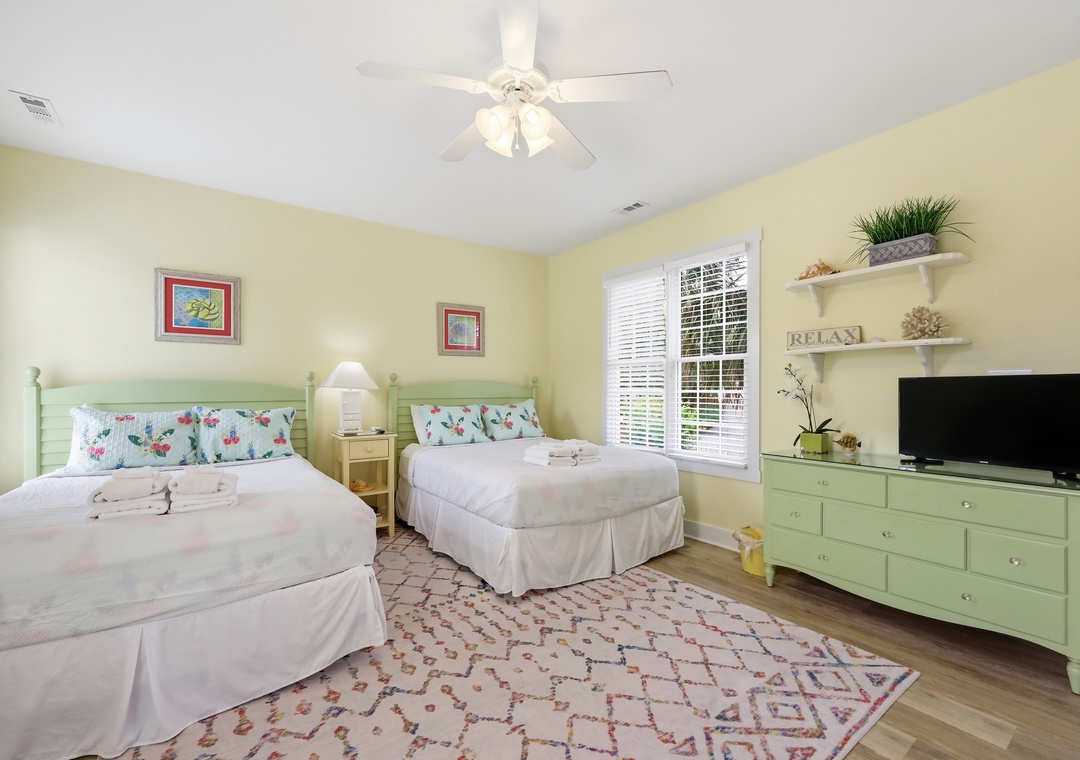 Unwind in your peaceful retreat with two plush beds, cheerful décor, and soft natural light inviting you to relax and recharge after a day of adventure.