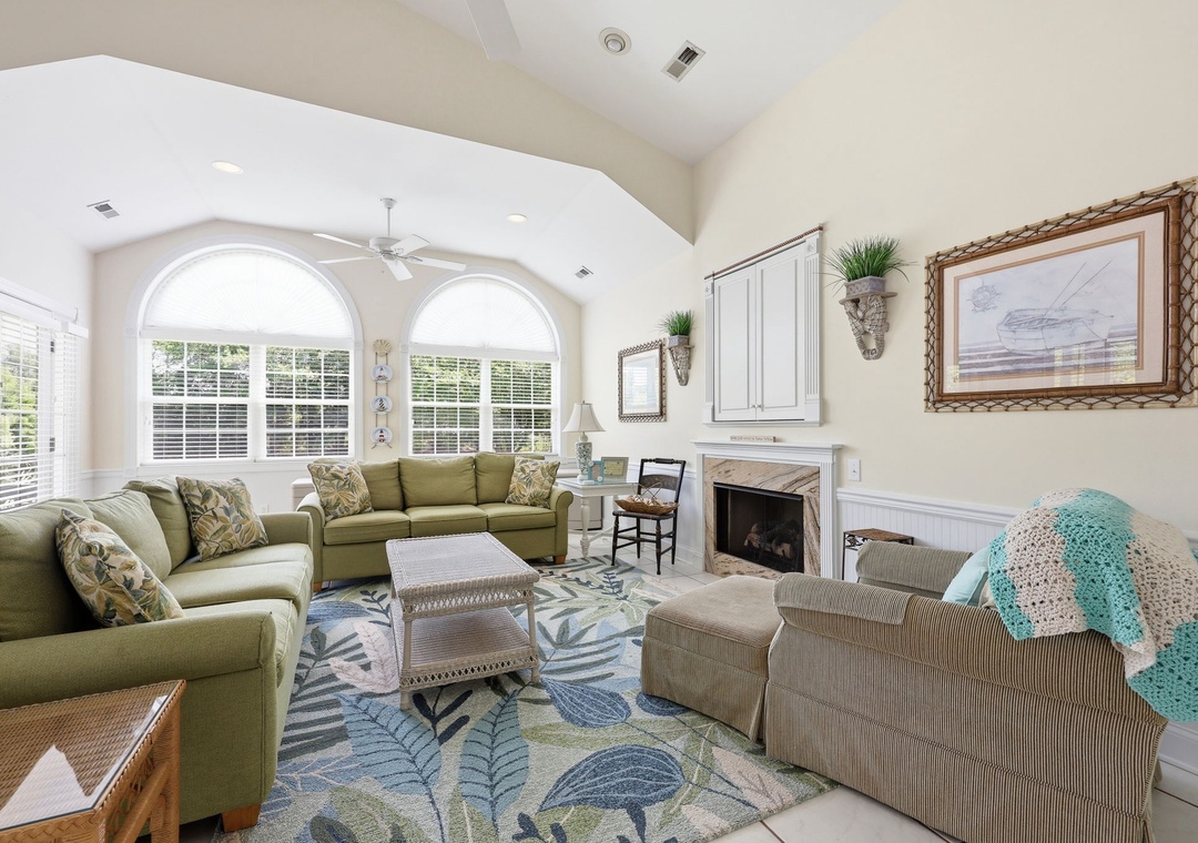 Settle into your serene retreat with soaring ceilings and abundant natural light. Relax by the fireplace or gather with loved ones in this bright, welcoming space designed for comfort and connection.