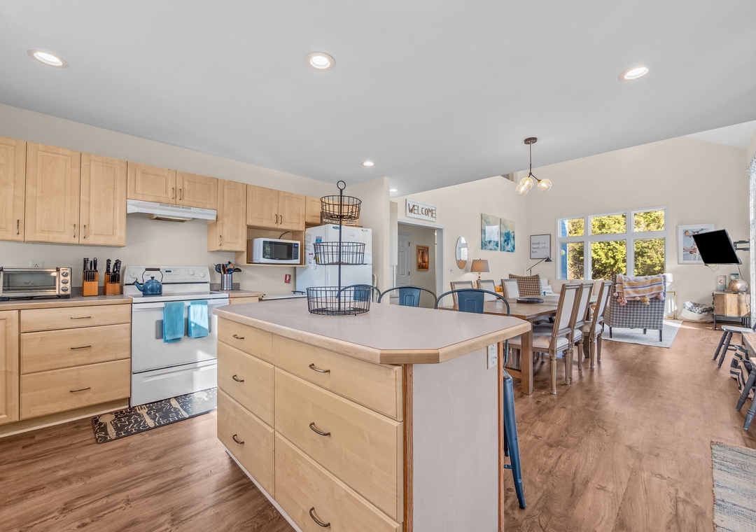 Your bright open-concept kitchen features warm wood cabinets and flows seamlessly into the dining and living areas—perfect for gathering.