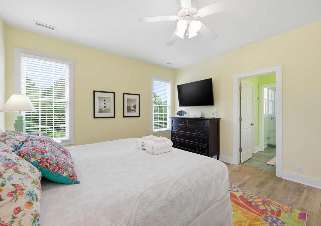 Unwind in your sunny bedroom, complete with fresh linens, a flat-screen TV, and a bright en-suite bathroom—your perfect retreat after a day of adventure.