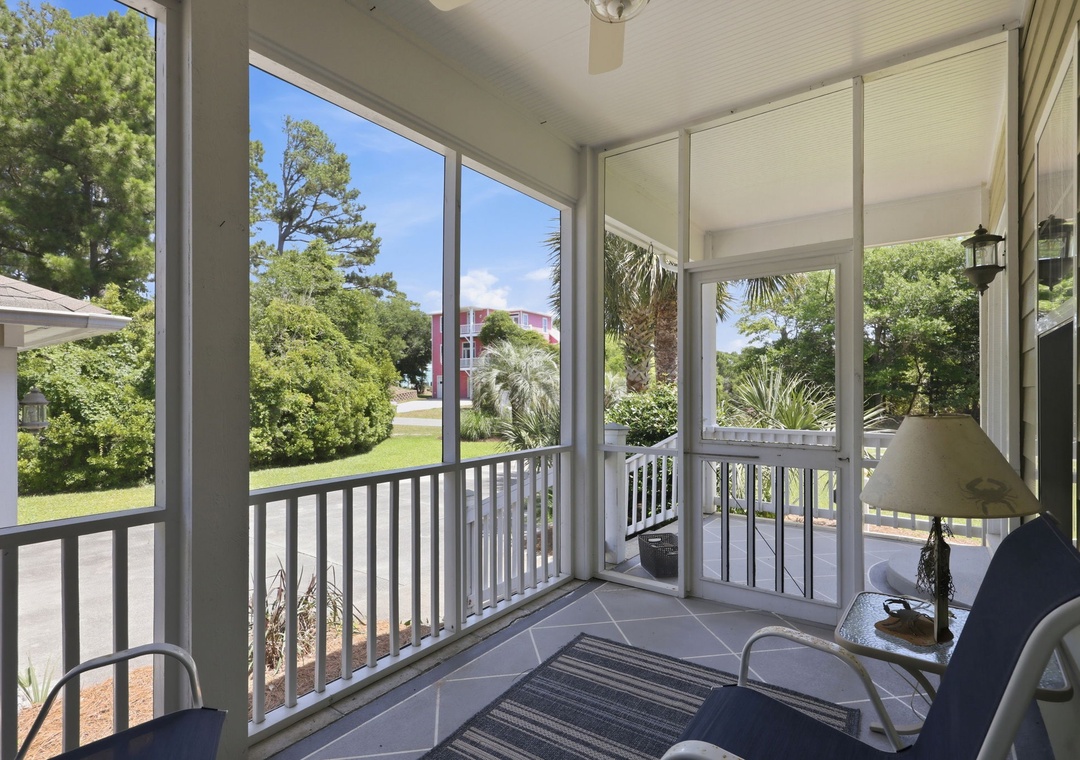 Relax on your screened porch with views of lush greenery and palms. Enjoy morning coffee or unwind at dusk in this bright, breezy space—perfect for savoring peaceful moments outdoors.