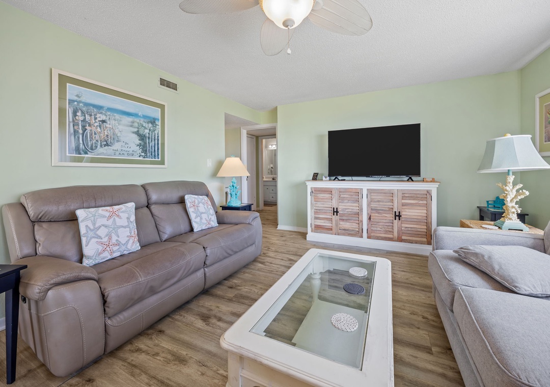 Sink into plush leather sofas while cool ocean breezes from the ceiling fan create your perfect retreat atmosphere.