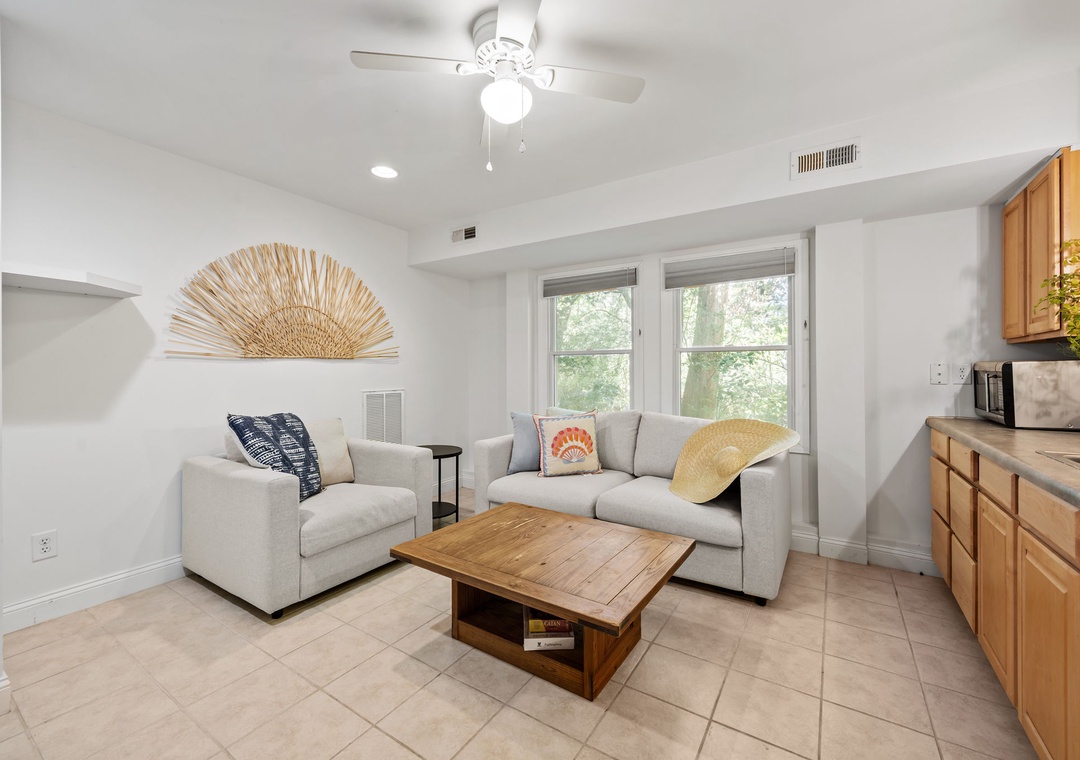 Unwind in your bright living space with plush seating, natural light streaming through large windows, and stylish touches creating the perfect retreat atmosphere.