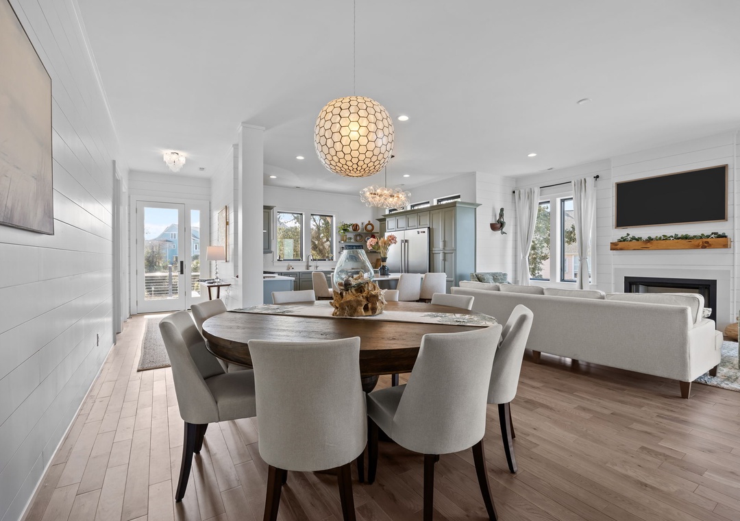 You'll love gathering around this elegant round dining table while enjoying the open-concept living space with stunning pendant lighting.