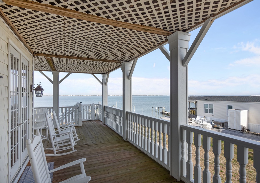 Relax in your private rocking chairs on this covered waterfront porch, where stunning sound views stretch endlessly before you.
