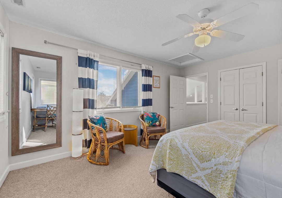 Relax in your bright coastal bedroom with tropical wicker seating, nautical curtains, and city views through oversized windows.