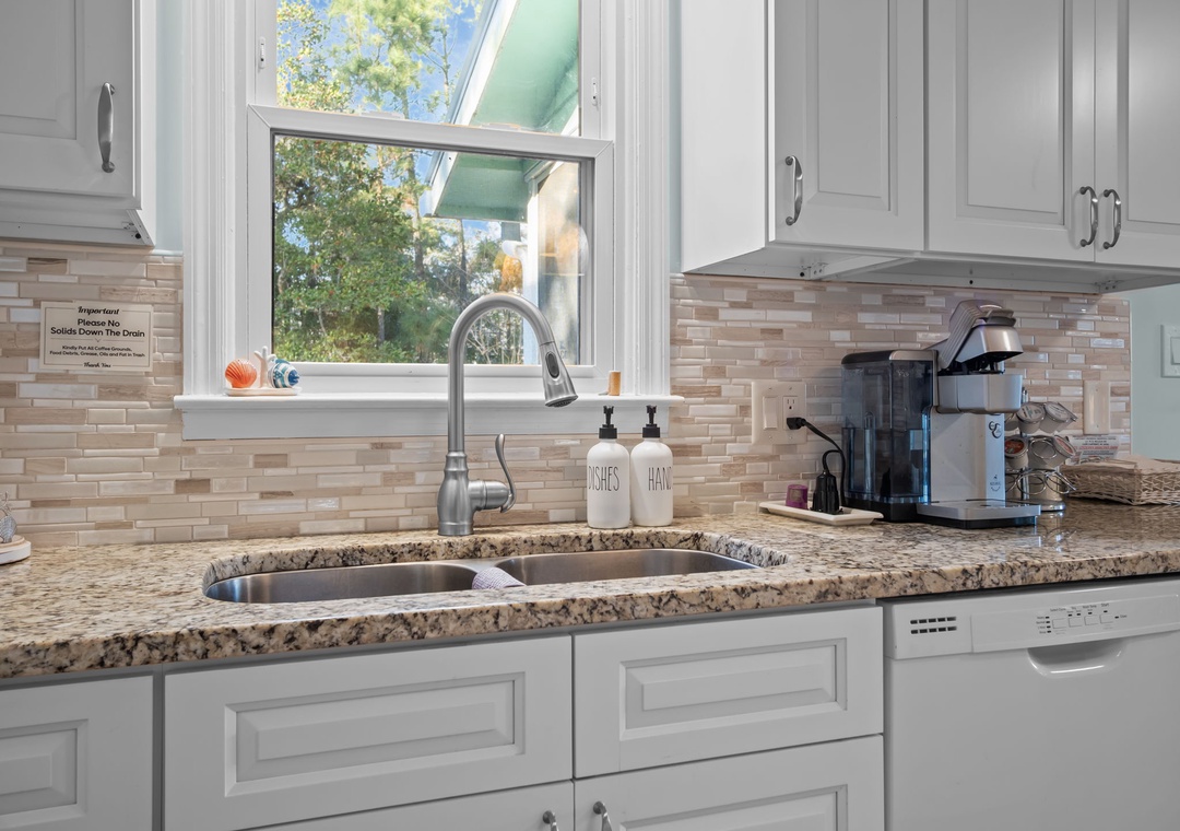Your fully equipped kitchen features granite countertops, modern appliances, and a garden view window for cooking with natural light.