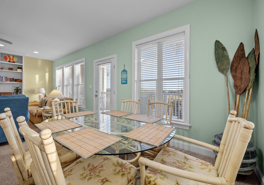 Gather around this coastal-inspired dining space where bamboo chairs and tropical decor create the perfect setting for memorable meals together.
