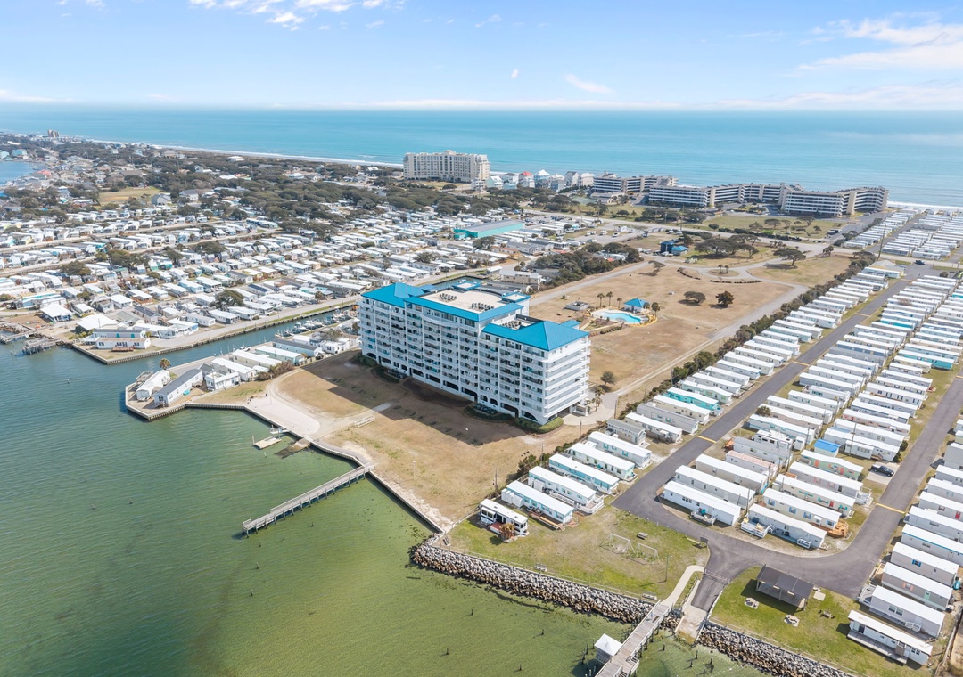 Aerial view of the coastal property with direct bay access and beachfront location in a vibrant waterfront community.