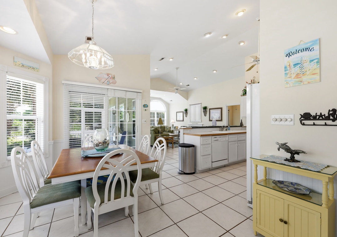 Gather around this inviting dining table where your mornings start with coffee and conversation. The open kitchen flows seamlessly into the living area, giving you plenty of room to cook, relax, and make vacation memories together.