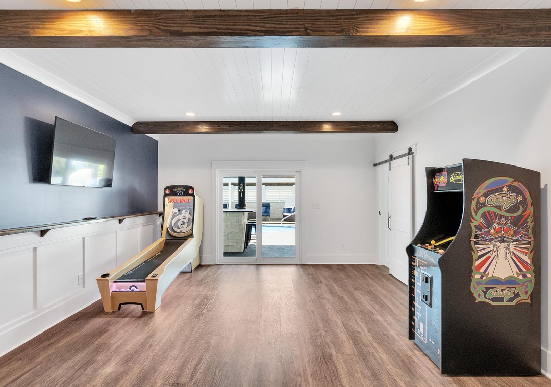 Enjoy friendly competition in your private game room with vintage arcade games, skeeball, and a large TV—perfect for family fun or group entertainment.