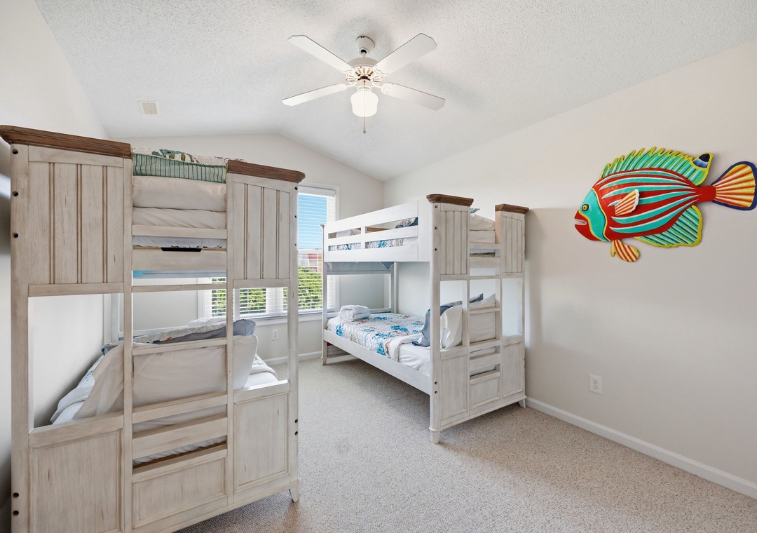 Your kids will love bunking together in this cheerful, beach-themed bedroom, where the colorful tropical fish and bright space invite endless fun and restful sleep.