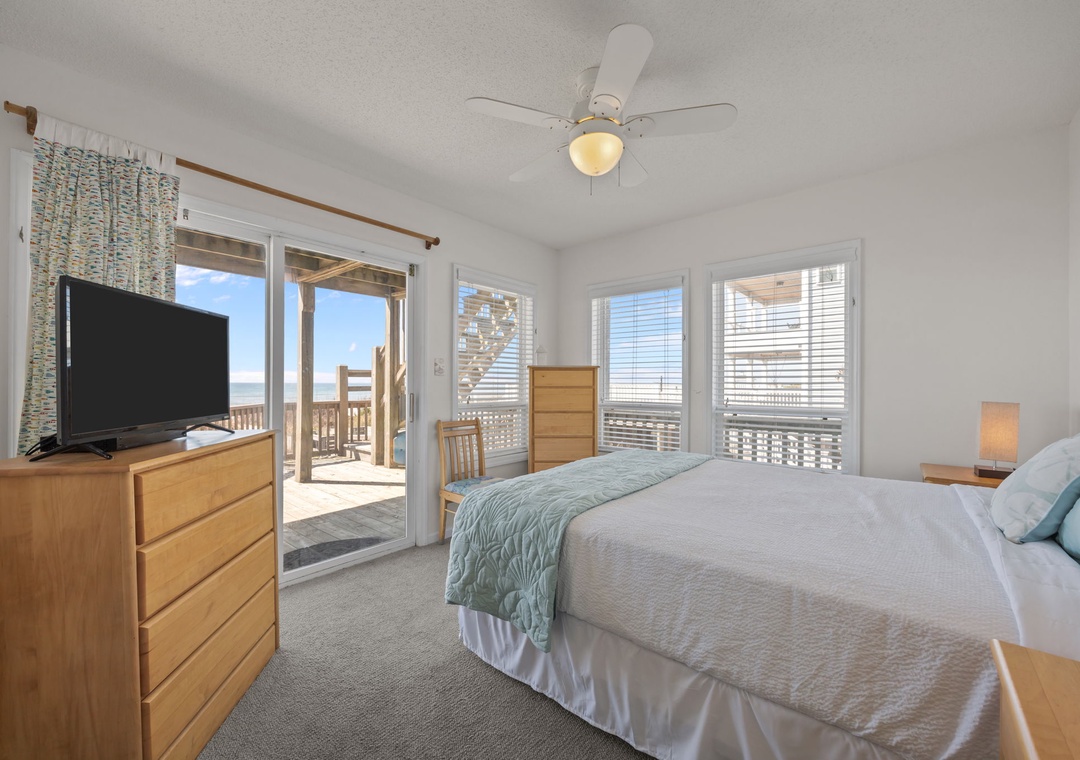 Wake up to stunning ocean views from your cozy bedroom, where gentle sea breezes flow through sliding doors to your private balcony.