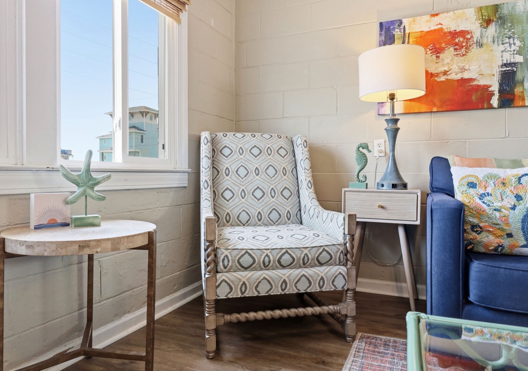 Unwind in your cozy reading nook with beachy décor, soft seating, and natural light inviting you to relax and recharge.